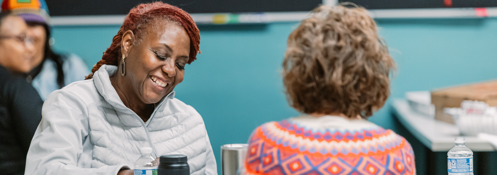 A group of women share a meal and talk together at a Parent Café